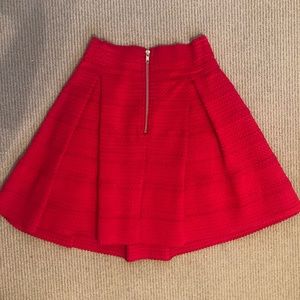 Bright red skirt with inverted pleat detail